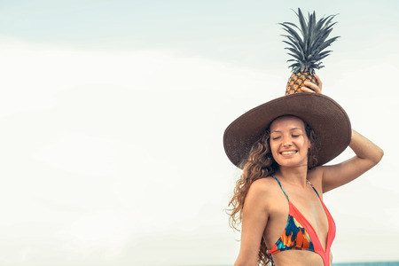 Happy young woman wearing swimsuit on tropical sand beach in summer for holiday travel vacation.の写真素材