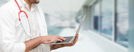 Doctor using laptop computer at the hospital. Medical healthcare and doctor staff service.の写真素材