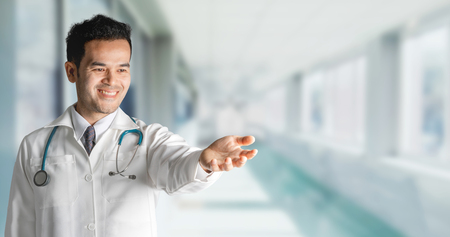 Male doctor at hospital opening hand palm to build copy space for your text and design. Medical healthcare business and doctor service.の写真素材