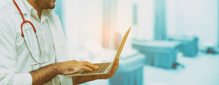 Doctor using laptop computer at the hospital. Medical healthcare and doctor staff service.