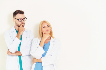Young doctors coworker thinking on white background. Healthcare and medical service concept.の写真素材