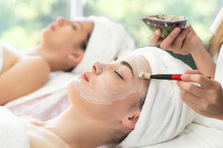 Beautiful woman having a facial cosmetic scrub treatment from professional dermatologistの写真素材