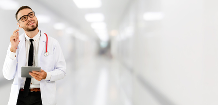 Doctor using tablet computer at the hospital. Medical healthcare and doctor staff service.の写真素材