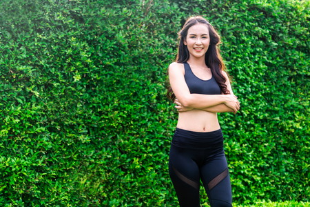 Young sport woman doing morning exercise in public park. Healthy lifestyle concept.の写真素材