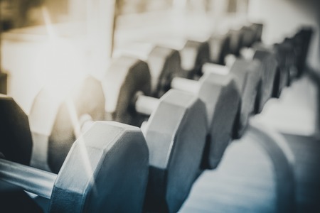 Dumbbells on rack in fitness center. Bodybuilding concept.の写真素材