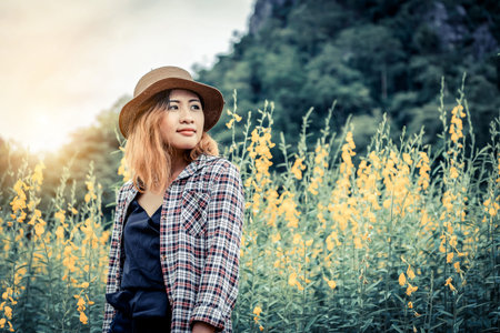 Young woman traveler walking in nature trail landscape. Travel and leisure concept.の写真素材