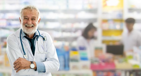 Senior male pharmacist working at the pharmacy. Medical healthcare and pharmaceutical service.の写真素材