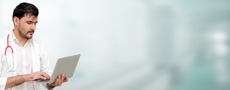 Doctor using laptop computer at the hospital. Medical healthcare and doctor staff service.の写真素材