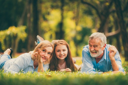 Happy family relaxing together in the park in summer. Concept of family bonding and relationship.の写真素材