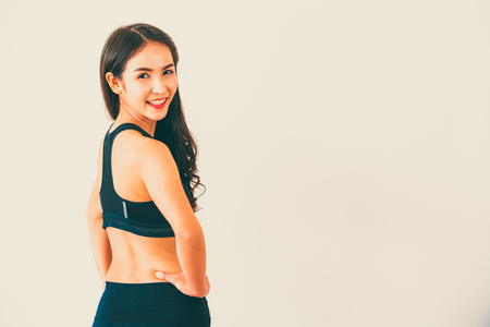Strong and confident Asian woman in fitness gym. Healthy lifestyle concept.の写真素材