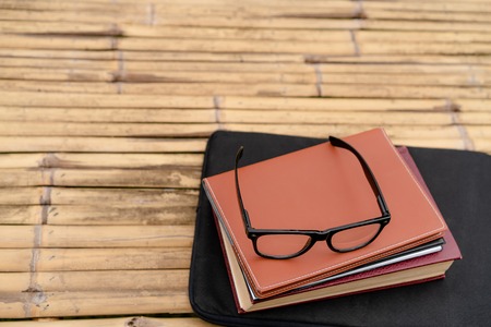 Soft focus retro style books and eye glasses with nature background. Reading and education concept.の写真素材