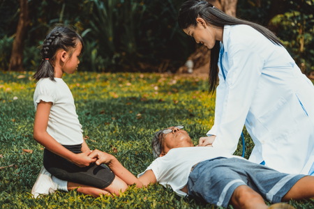 Senior man having chest pain or heart attack in the park. Old people elderly healthcare concept.の写真素材