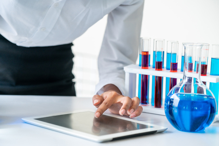 Woman scientist working in laboratory and examining biochemistry sample in test tube.の写真素材