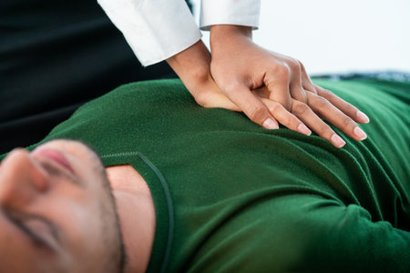 Rescuer hands doing emergency CPR on heart attacked man trying to save his life.