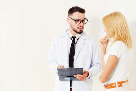 Male doctor and female patient with documents of patients health record are having conversation in hospital. Healthcare and medical service.の写真素材