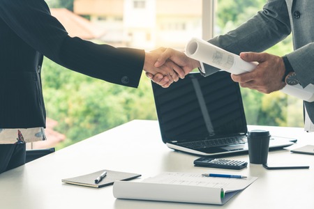 Businessman executive handshake with businesswoman worker in modern workplace office.の写真素材