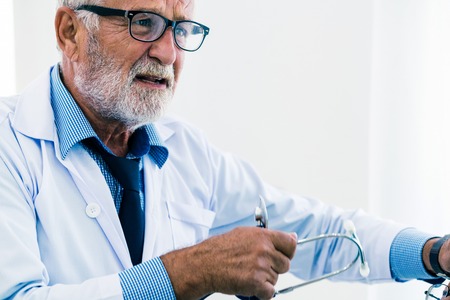 Senior male doctor working in hospital. Medical healthcare and doctor service.の写真素材