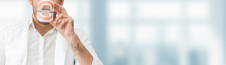 Young male dentist working in dental clinic. Dentistry care and medical service concept.