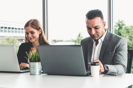 Businessman executive is in meeting discussion with a businesswoman worker in modern workplace office. People corporate business team concept.の写真素材