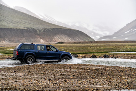 Landmannalaugar, Iceland - July 2, 2018: 4WD vehicle car travel off road in landscape of Landmannalaugar in highland of Iceland, Nordic, Europe. The place is famous for summer outdoor trekking way.のeditorial素材