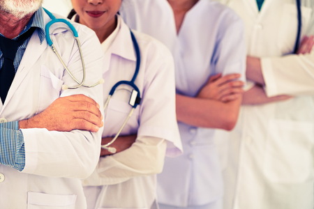 Healthcare people group. Professional doctor working in hospital office or clinic with other doctors, nurse and surgeon. Medical technology research institute and doctor staff service concept.の写真素材