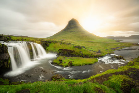 Breathtaking sunrise over Kirkjufell mountain landscape and waterfall in Iceland summer. Kirjufell is the beautiful landmark and the most photographed mountain which attracts tourist to visit Iceland.の写真素材