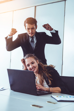 Businessman boss feels angry and mad at bad misbehaving businesswoman employee who ignores the work tasks at the workplace. Firing workers and human resources management problem concept.の写真素材