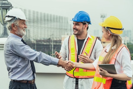 Engineer, architect and business man working on the engineering project at construction site. House building concept.の写真素材