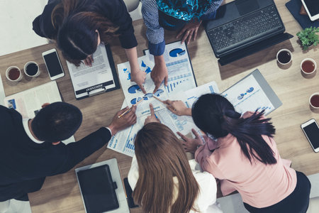 Top view of businessman executive in group meeting with other businessmen and businesswomen in...