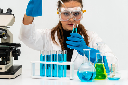 Young woman scientist working in chemical laboratory and examining biochemistry lab sample.の写真素材