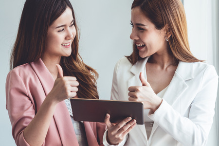 Businesswoman executive is in meeting discussion with another businesswoman or client in modern workplace office.の写真素材