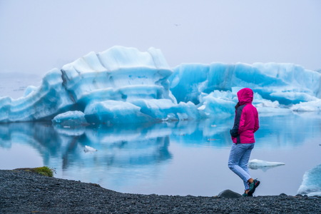 Woman traveler travels to Jokulsarlon beautiful glacial lagoon in Iceland.の写真素材