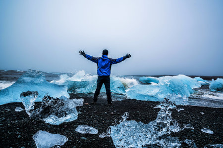 Young man traveler travel to Diamond Beach in Iceland.