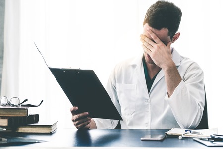 Doctor working in hospital office. Medical healthcare concept.の写真素材