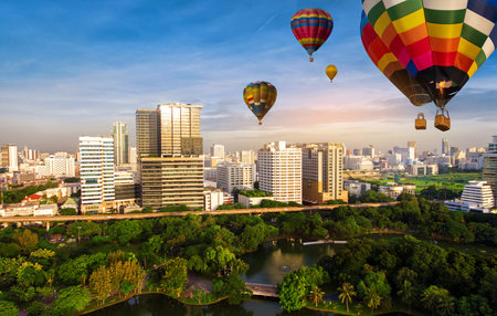 Beautiful panoramic urban cityscape in modern metropolis with colorful high hot air balloons...