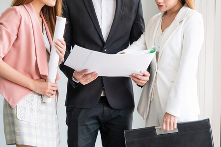 Businessman is in meeting discussion with colleague businesswomen in modern workplace office. People corporate business team concept.の写真素材