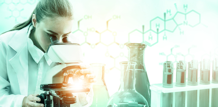 Research and development concept. Double exposure image of scientific and medical lab instrument, microscope, test tube and glass flask for microbiology and chemistry in laboratory for medicine study.の写真素材