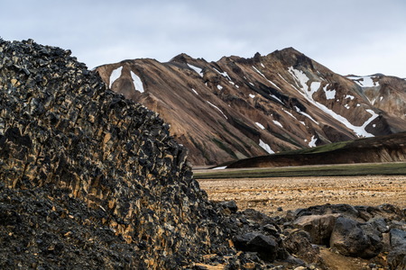 Landscape of Landmannalaugar surreal nature scenery in highland of Iceland, Nordic, Europe. Beautiful colorful snow mountain terrain famous for summer trekking adventure and outdoor walking.の写真素材
