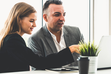 Businessman executive is in meeting discussion with a businesswoman worker in modern workplace office. People corporate business team concept.の写真素材