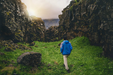 Man traveler and explorer travels in the Icelandic landscape hiking across Iceland to discover...