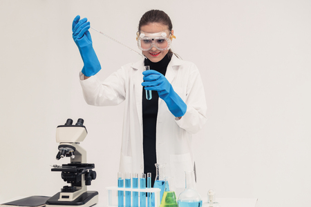Young woman scientist working in chemical laboratory and examining biochemistry lab sample. Science technology medicine research and development study concept.の写真素材