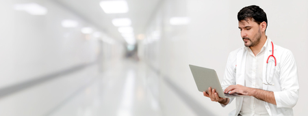 Doctor using laptop computer at the hospital. Medical healthcare and doctor staff service.の写真素材