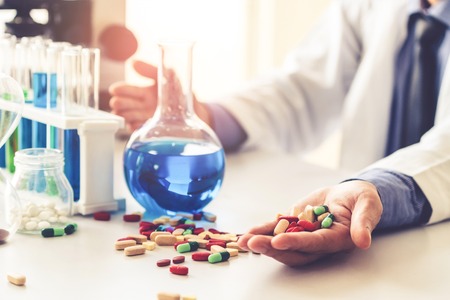 Colorful medicine pills and tablets in pharmaceutical lab. Concept of medical technology research and development for future cure of illness.の写真素材