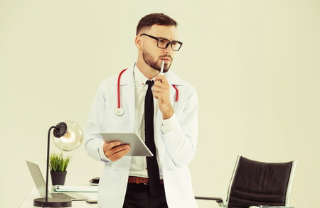 Doctor working on tablet computer at office in the hospital. Medical and healthcare concept.の写真素材