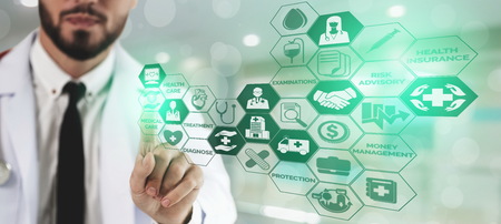 Health Insurance Concept - Doctor in hospital with health insurance related icon graphic interface showing healthcare people, money planning, risk management, medical treatment and coverage benefit.の写真素材