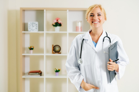 Young female doctor working in hospital office. Medical and healthcare concept.の写真素材