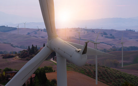 Wind turbine farm power generator in beautiful nature landscape for production of renewable green...