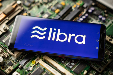 Bangkok, Thailand - July 2, 2019: Phone shows Libra logo on the screen. Facebook reported to utilize...