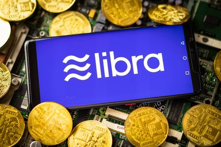 Bangkok, Thailand - July 2, 2019: Phone shows Libra logo on the screen. Facebook reported to utilize new cryptocurrency called Libra. Libra was reported to be used for purchases in Facebook and other.のeditorial素材