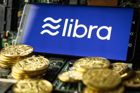 Bangkok, Thailand - July 2, 2019: Phone shows Libra logo on the screen. Facebook reported to utilize...